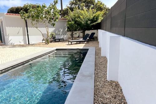 a swimming pool in the backyard of a house at New Beach House near main street close PraiaGrande in Colares