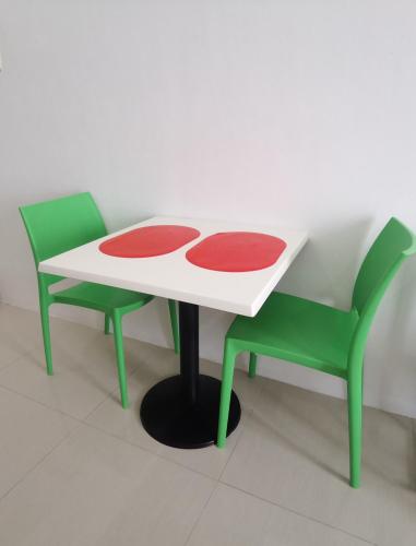 a table and two chairs in a room at Affordable Condo w/ Shower Heater and Wi-Fi in Minglanilla