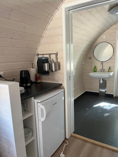 a small kitchen with a sink and a door open at Helle Aktivitetshotel in Årre