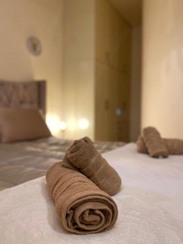 two towels are sitting on top of a bed at Delfi's cozy maisonette in Delfoi