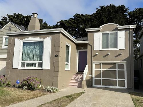 a brown house with a window and a driveway at The Olympic- Mid-Century Home on the Golf Course in Daly City