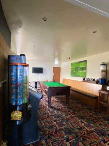 a hotel room with a pool table and a couch at South Beach Hotel in Blackpool