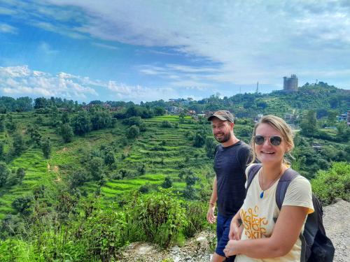 a man and a woman standing on top of a hill at Himchuli Guest House in Bandīpur
