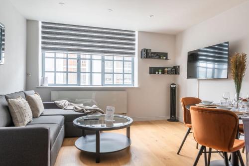 a living room with a couch and a table at The Eyre Suite Six - Farringdon - by Frankie in London