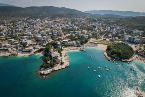 an aerial view of a beach with boats in the water at HOTEL DENOEL in Ksamil