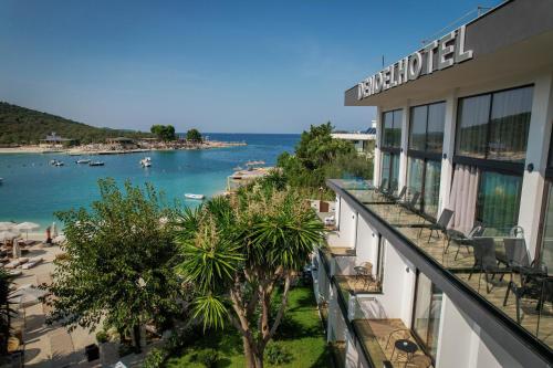 a hotel with a view of a beach and the ocean at HOTEL DENOEL in Ksamil