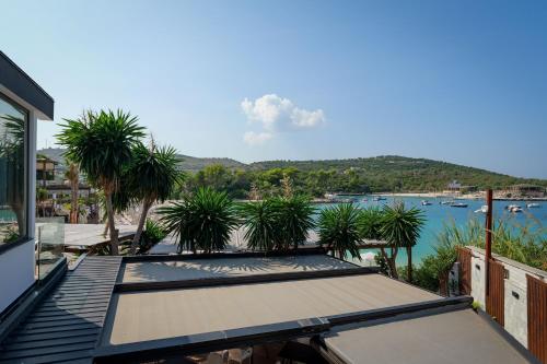 a balcony with a view of a body of water at HOTEL DENOEL in Ksamil