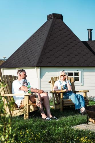 a man and woman sitting on chairs in the grass at Mawgies in Saint Ervan