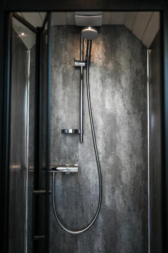 a shower with a shower head in a bathroom at Mawgies in Saint Ervan