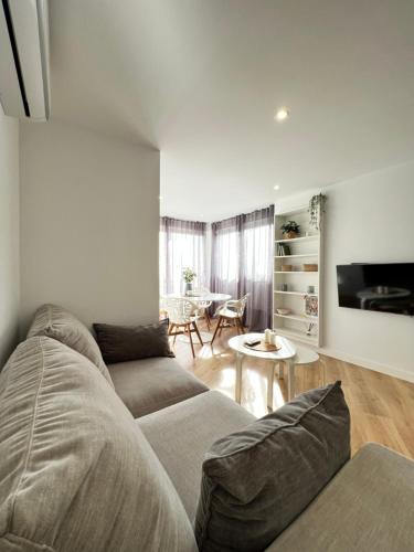 a living room with a couch and a table at PARAISO DEL SOL in Benajarafe
