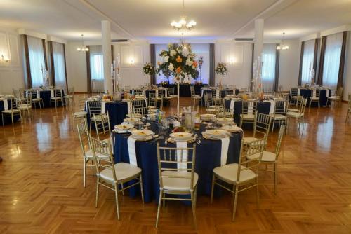 a banquet hall with tables and chairs in a room at Gościniec Uniejów in Uniejow