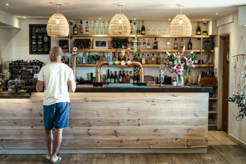 a man standing at a bar at Mawgies in Saint Ervan