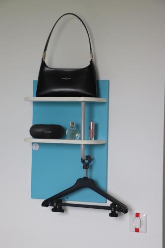 a shelf with a black purse on top of it at First Inn Hotel Blois in Blois
