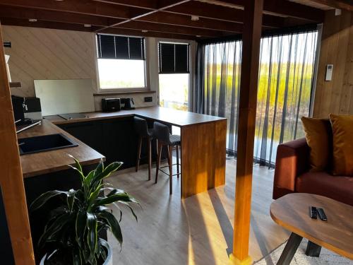 a kitchen and living room with a table and a couch at Feel the breeze - cozy luxury in Elva