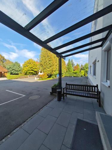 a building with a bench in a parking lot at Apartment E2 - Gut ausgestattete 3-Zimmerwohnung 64 qm, für 1-3 Personen 1 DZ 1EZ in Gravenwerth