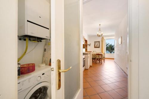 a kitchen and living room with a washer and dryer at Appartamento Celsi in Moneglia