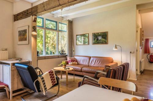 a living room with a couch and a table at Appartementen BuitenWedde Westerwolde in Wedde