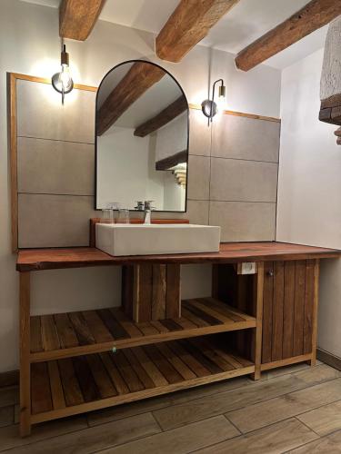 a bathroom with a sink and a mirror at Domaine de Couilleuse in Saint Laurent Nouan