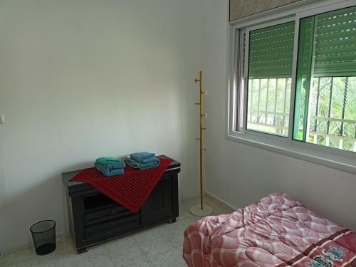 a bedroom with a bed and a table and a window at BnB La Luna Entire Apartment in Jericho
