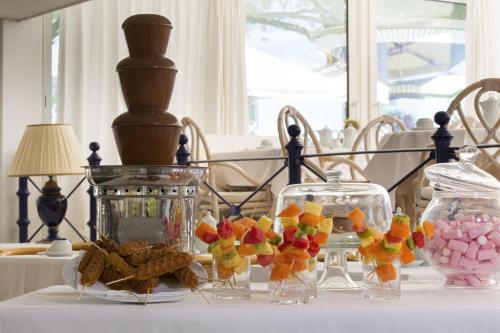 a table with two glass vases filled with candy at Park Hotel Brasilia in Lido di Jesolo