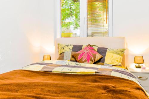 a bedroom with a bed with pillows and two lamps at Sofia's Best Kept Secret in Prime Location! in Sofia