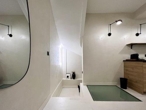 a bathroom with a mirror on the wall at Superb Apartment Palais Royal Louvre Museum in Paris