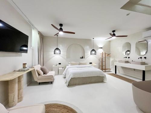 a white bedroom with a large bed and a sink at Superb Apartment Palais Royal Louvre Museum in Paris