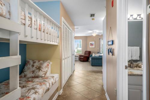 a hallway with a staircase with a bench in a room at Grande Caribbean 326 in Orange Beach