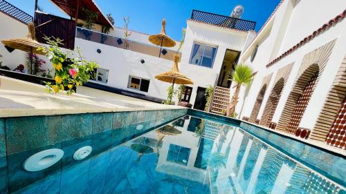 a swimming pool in a house with frisbees in it at Dar Najat in Marrakech