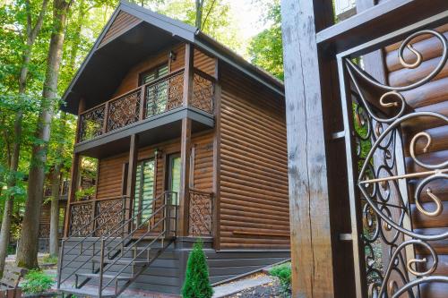 a house in the woods with a gate at Готельно-ресторанний комплекс БОЖЕДАР in Vinnytsya