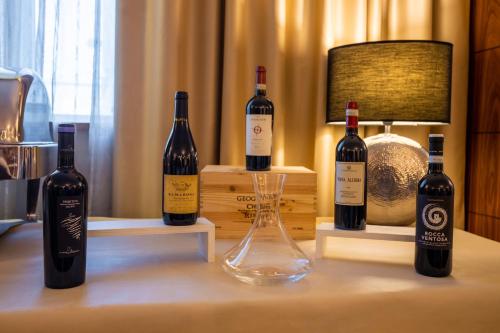 three bottles of wine sitting on a table at Papillo Hotels & Resorts Roma in Rome