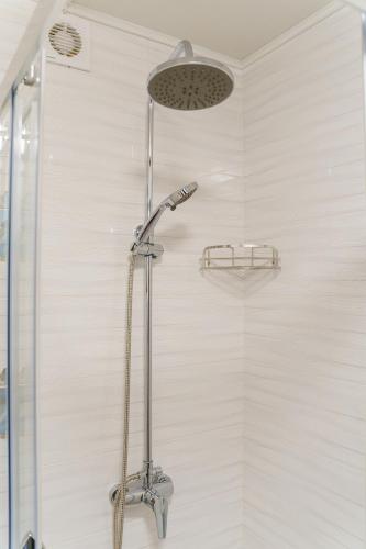 a shower with a shower head in a bathroom at Готельно-ресторанний комплекс БОЖЕДАР in Vinnytsya
