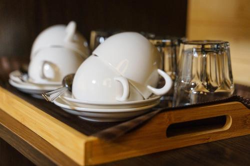 a group of white cups and plates on a table at Готельно-ресторанний комплекс БОЖЕДАР in Vinnytsya
