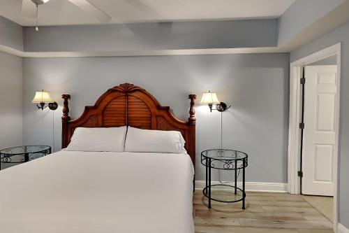 a bedroom with a large bed and two tables at The Village 514 in Blue Mountain Beach