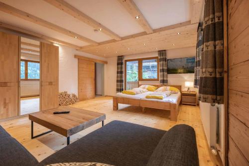 a living room with a bed and a table at Haus Alpenkönig in Neustift im Stubaital