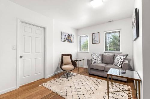 a living room with a couch and a chair at Opulent 2 Bedroom Getaway in Detroit