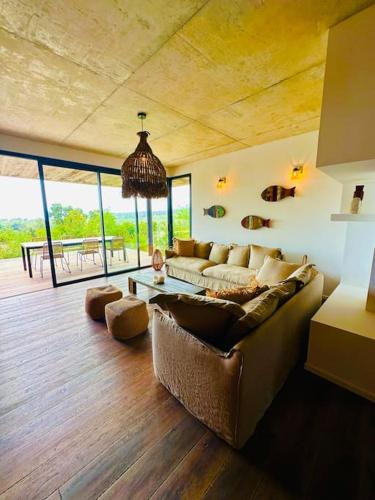 un salon avec un canapé et une table dans l'établissement Loft *Piscine chauffée* Vue mer, à Zonza