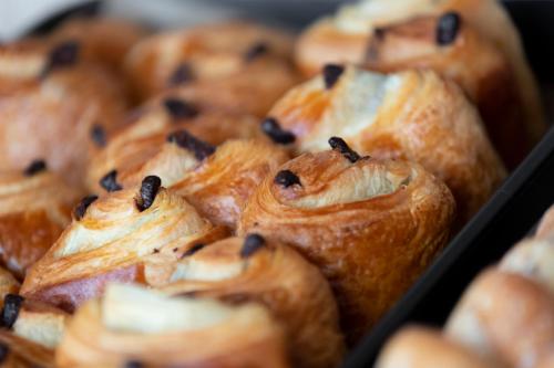 a bunch of pastries with raisins in a tray at Aparthotel 37 Lodge Courbevoie Paris La Défense in Courbevoie