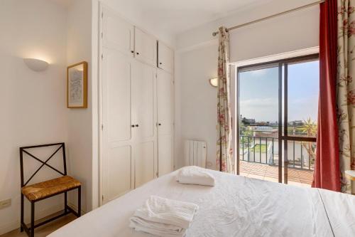 a bedroom with a bed and a large window at Sea View Estoril in Estoril