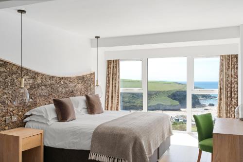a bedroom with a bed and a large window at Bedruthan Hotel & Spa in Newquay