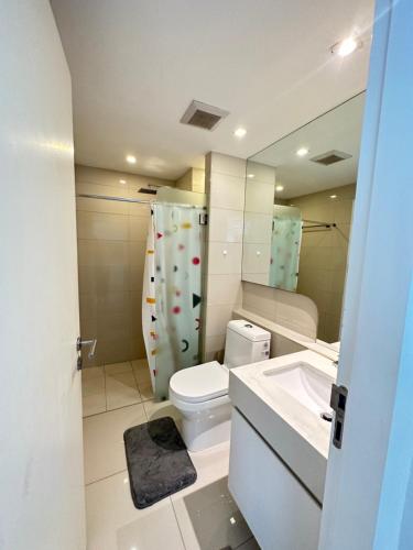 a bathroom with a toilet and a sink and a mirror at City Center Residence - Pool view in Pattaya Central
