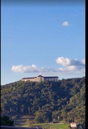 a building on top of a hill with trees at Hotel Vista Azul in Domingos Martins