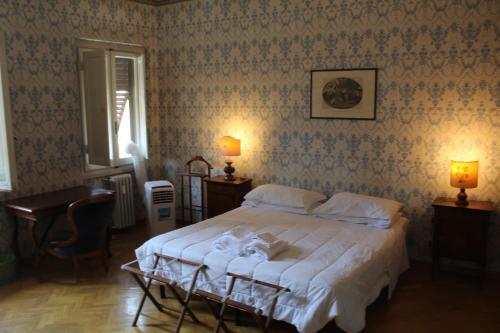 a bedroom with a bed and a table and lights at Hotel Dali in Florence