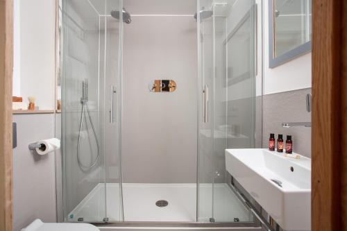 a bathroom with a glass shower and a sink at Bedruthan Hotel & Spa in Newquay