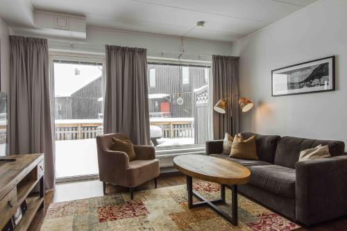 a living room with a couch and a table at Funäs Ski Lodge in Funäsdalen