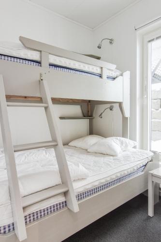 a bedroom with two bunk beds and a window at Funäs Ski Lodge in Funäsdalen
