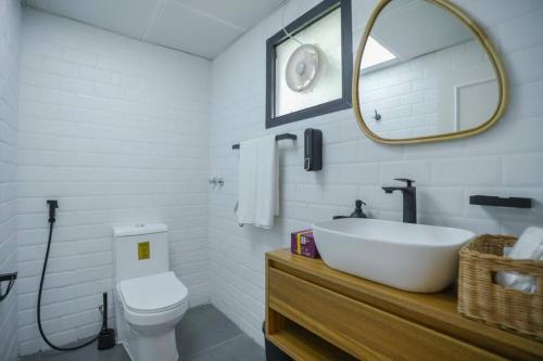 a bathroom with a sink and a toilet and a mirror at Perfect villa for your vacation in Dubai