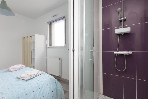 łazienka z łóżkiem i prysznicem w obiekcie Maison Quenvel Morgat - À 5min de la plage w mieście Crozon