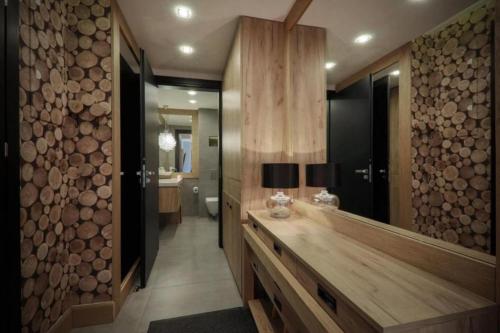 a bathroom with a wooden counter with a large mirror at Apart-Center Pod Gwiazdami SPA in Zakopane