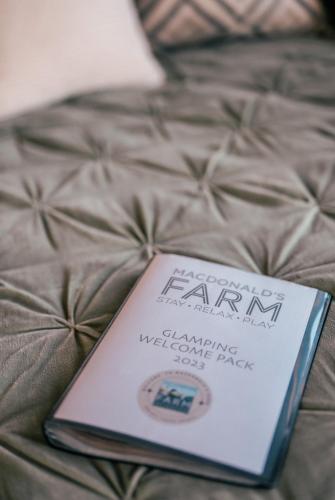 a book sitting on top of a bed at The Potting Barn in Saint Ervan